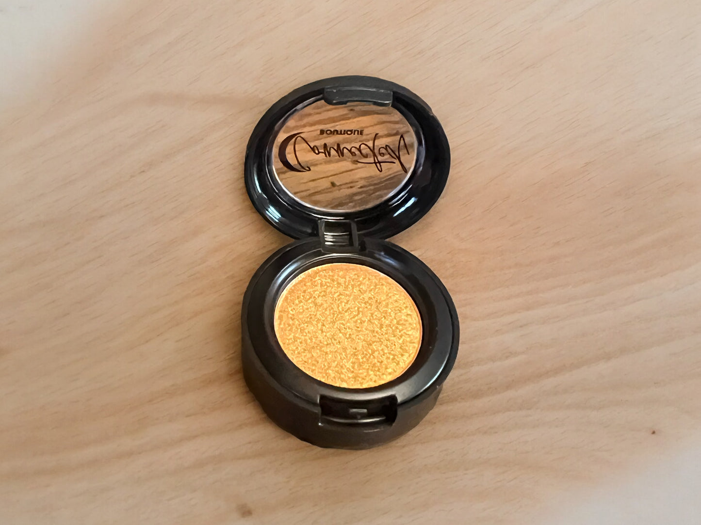 “Astral Kiss” orange shimmer single eyeshadow